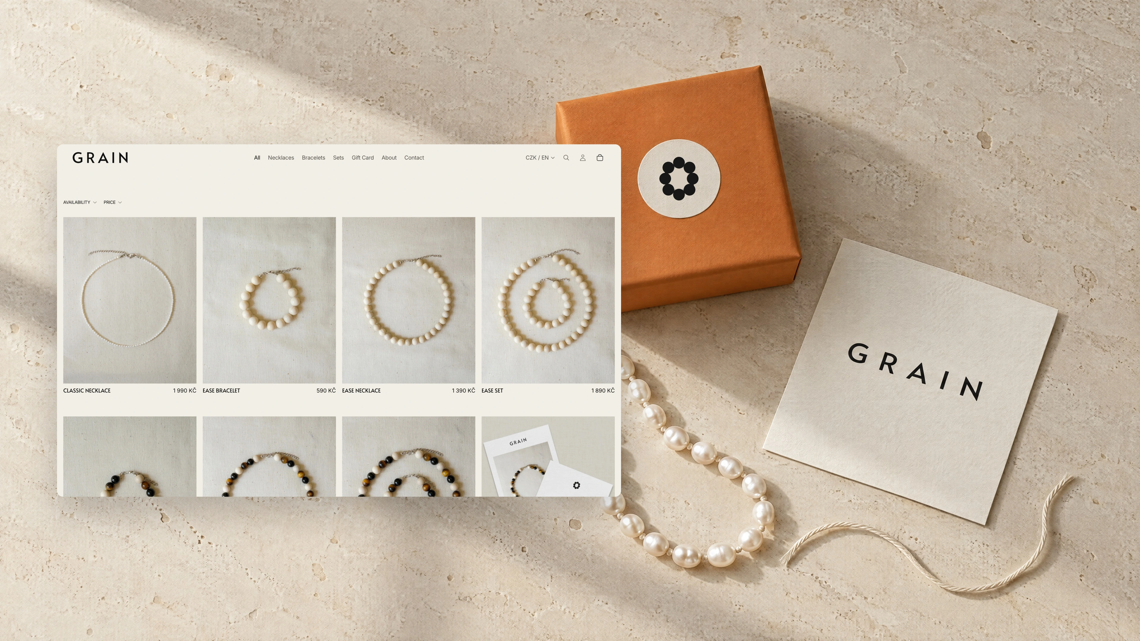GRAIN all-products page over an orange gift box with the bead symbol sticker and a GRAIN card