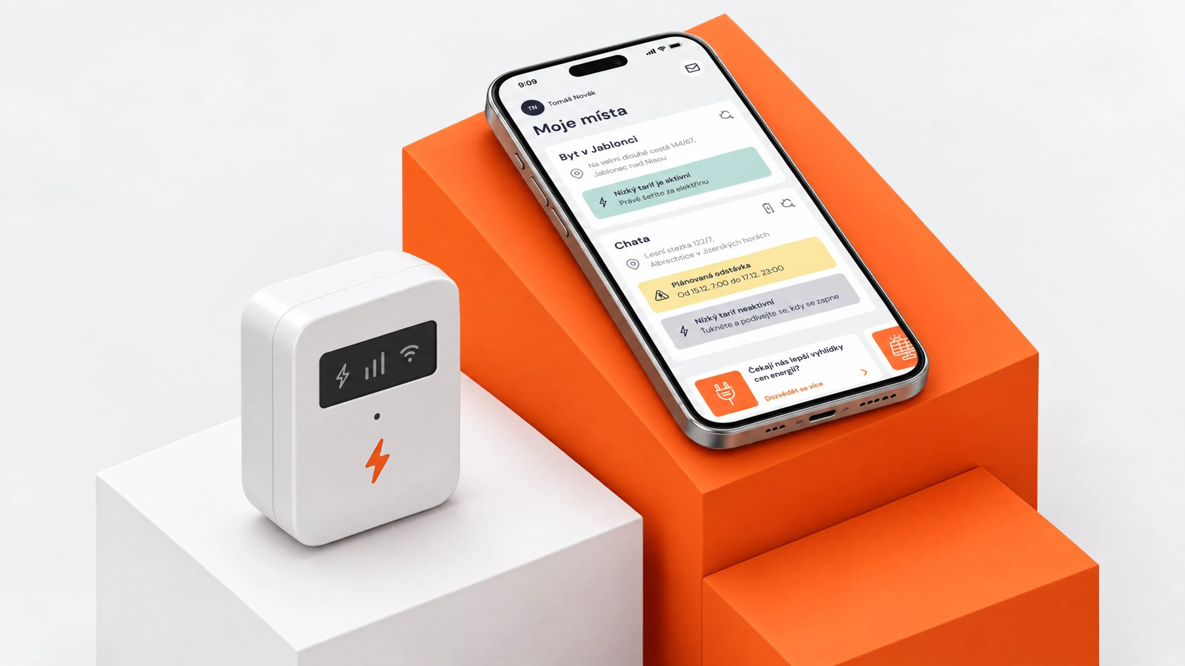 Phone with the Proud home screen on orange and white blocks beside an electricity meter