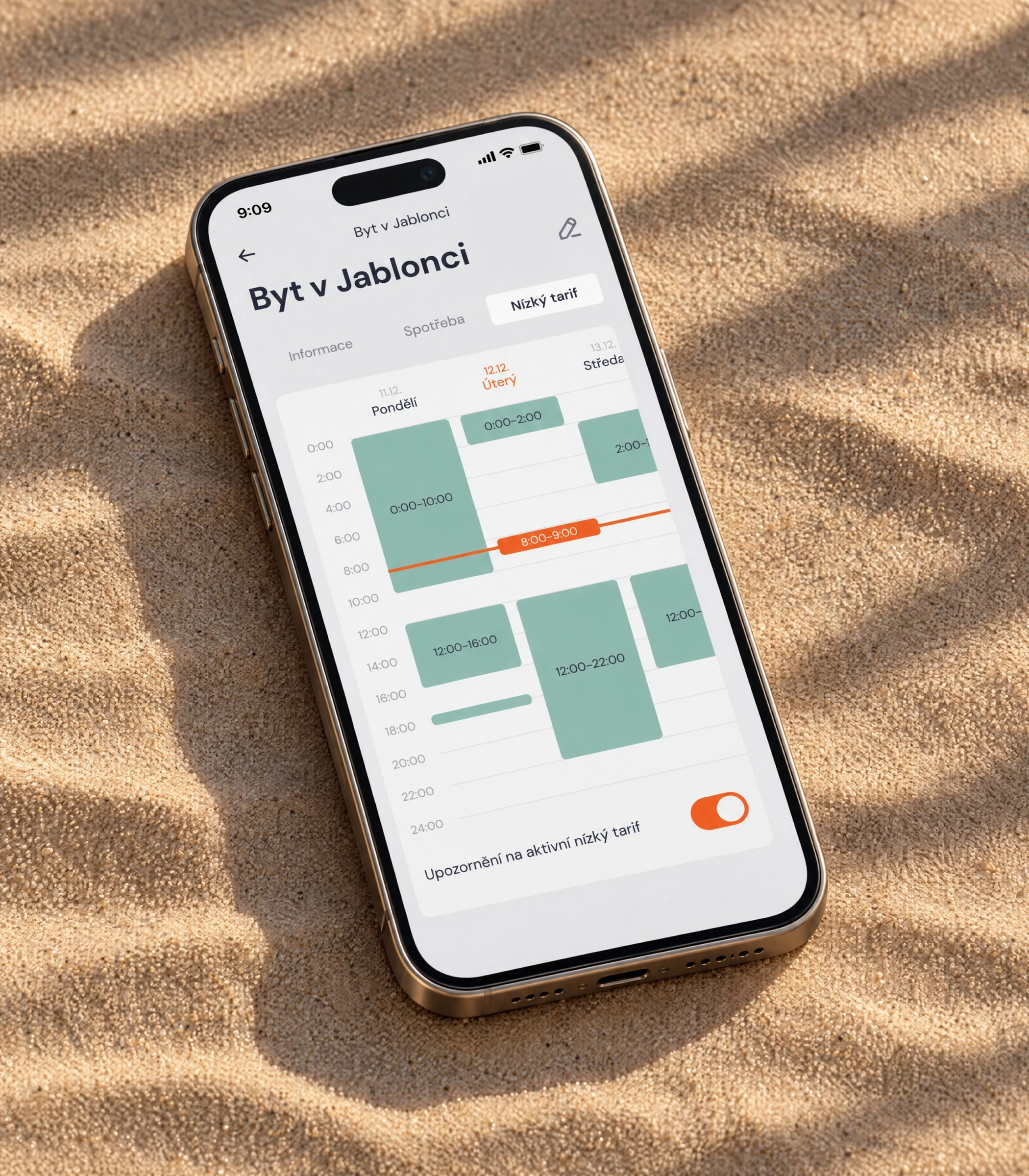Phone on sand in palm shadow showing the low-tariff calendar